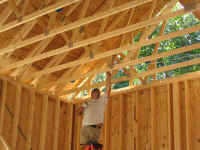 Me, on my 12' ladder, installing Romex on a ceiling truss.